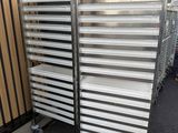 stainless steel trays stacked on top of each other in front of a building
