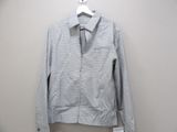 the jacket is hanging on a hanger on the wall
