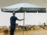 a man that is standing under an umbrella in a room