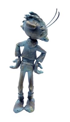 a statue of a boy with a bird on his head