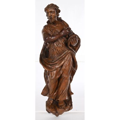 a wooden statue of a man holding a child