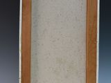an old picture frame with a white background and brown trim