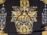 a black and gold table cloth with gold decorations on it