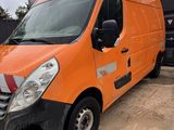 an orange van parked in a parking lot next to a dumpster