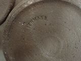 a close up of a metal object with a name on it