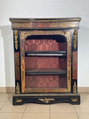 an antique black and gold painted cabinet with shelves and shelves