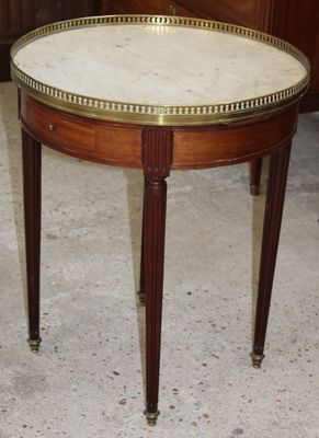 a small table with a marble top on the floor