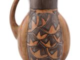 a brown and black pitcher on a white background