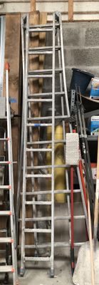 many ladders that are leaning against the wall