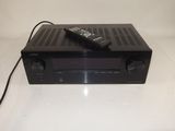 an image of a remote control sitting on top of a receiver