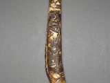 a close up of a wooden stick with carvings on it