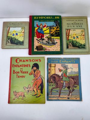 four children ' s books are lined up on a white surface