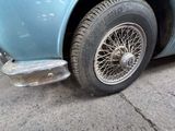 a close up of a car with a tire on the street