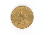 a gold coin with a bird on it on a white surface