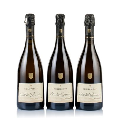 three bottles of wine sitting next to each other on a white surface