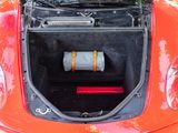 an open trunk of a red car with a roll of toilet paper in it