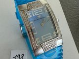 a blue watch on display on a table with a price tag