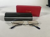 glasses are sitting on a table next to a red box