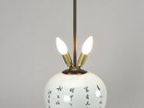 a white lamp with a black base and a gold base