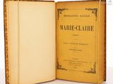 an open book with a yellow cover sitting on top of a white table