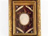 an old picture frame with a picture in it hanging on a wall