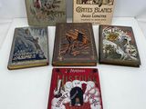 several books are sitting on a table with a white background