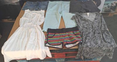 a pile of clothes that is sitting on a table