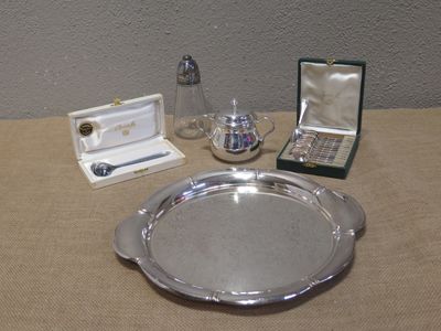 a silver tray on a table with other items on it