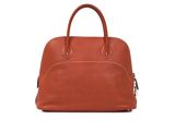 an image of a brown leather handbag on a white background