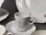 a lot of plates and cups sitting on a table