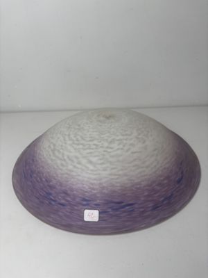 a purple and white bowl sitting on a white surface
