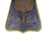 a brown bag with a brown handle sitting on a blue mat