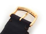 a black leather strap with a gold buckle on it
