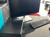 a computer desk with a monitor, keyboard, mouse and mouse
