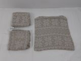 trois morceaux de tissu posés sur un lit recouvert d'un drap blanc