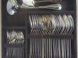 a lot of spoons and forks in a black box