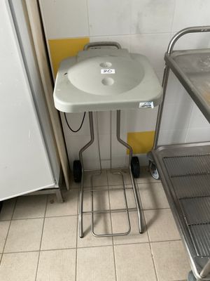 a small table with a sink in the corner of a room