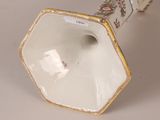 a white vase with a gold trim on it