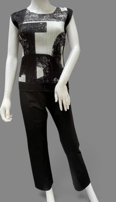 an image of a mannequin wearing a black and white top and pants