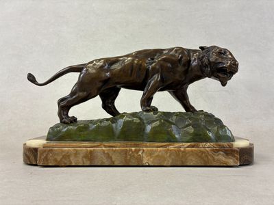bronze sculpture of a tiger on a rock on a white background