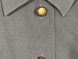 the back of a gray jacket with gold buttons on a mannequin mannequin mannequin mannequin mannequin mannequin mannequin