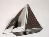a mirror that has a sailboat on it on the wall