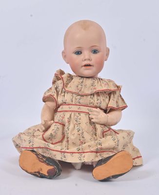 an image of a baby doll sitting on the ground with a white background