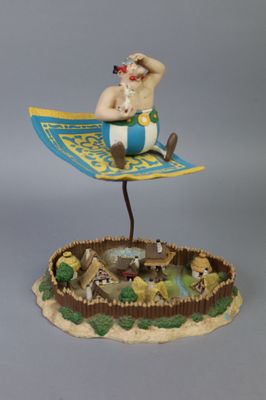 a figurine of a man sitting on top of a boat