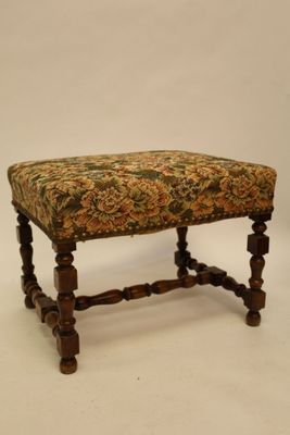 an image of a foot stool with a floral upholstered seat