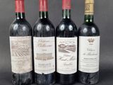 three bottles of wine are lined up on a table