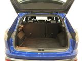the back of a blue car with its trunk open and the back seats down