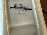 a white plate with a black writing on it