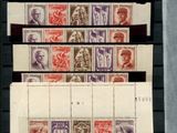 several stamps of different colors and sizes on a black surface