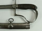 a knife that is laying on top of a piece of metal
